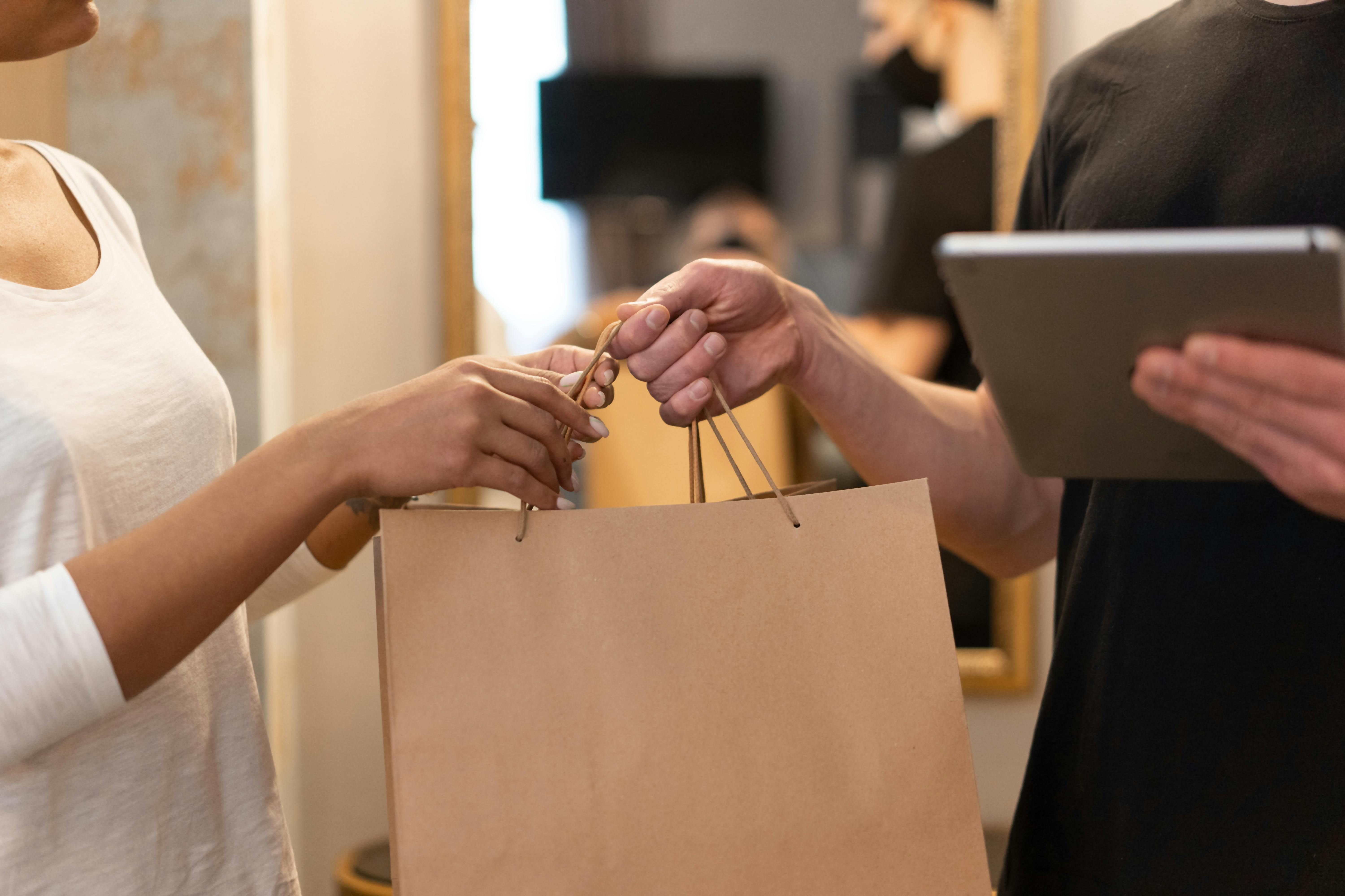 customer being handed shopping bag
