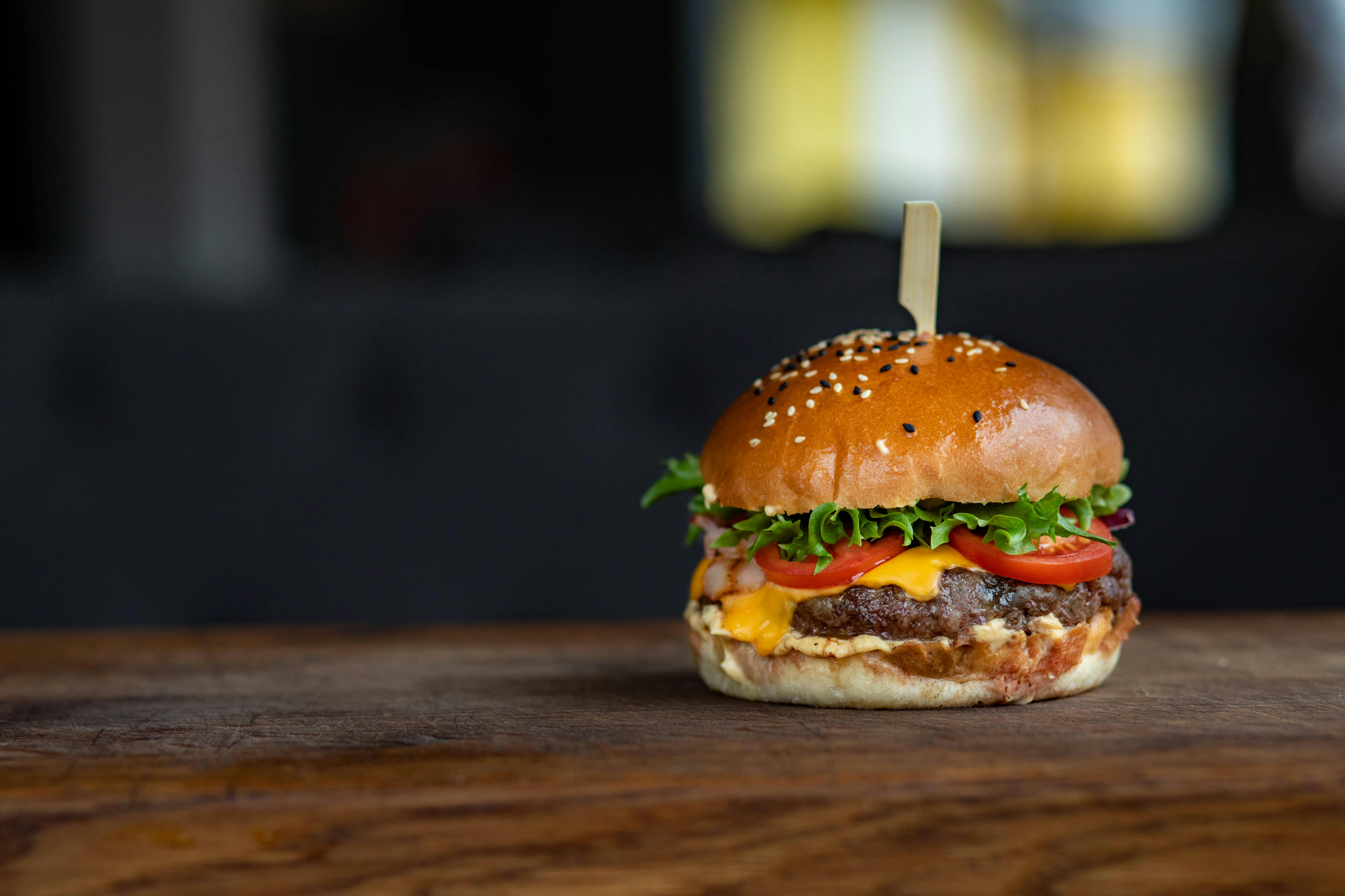 hamburger with sesame bun with pick in middle