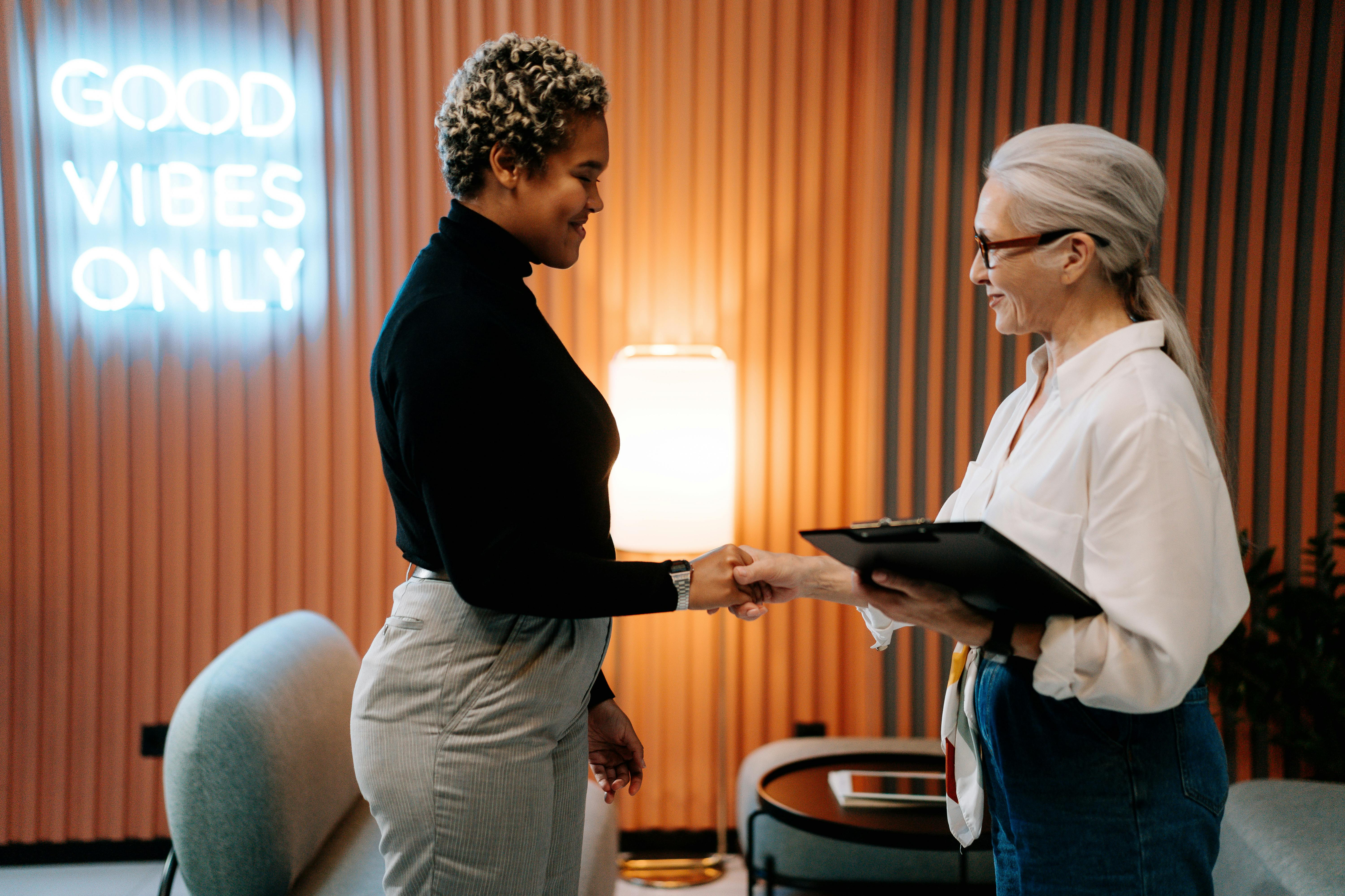 Human resources manager shaking hand of new employee