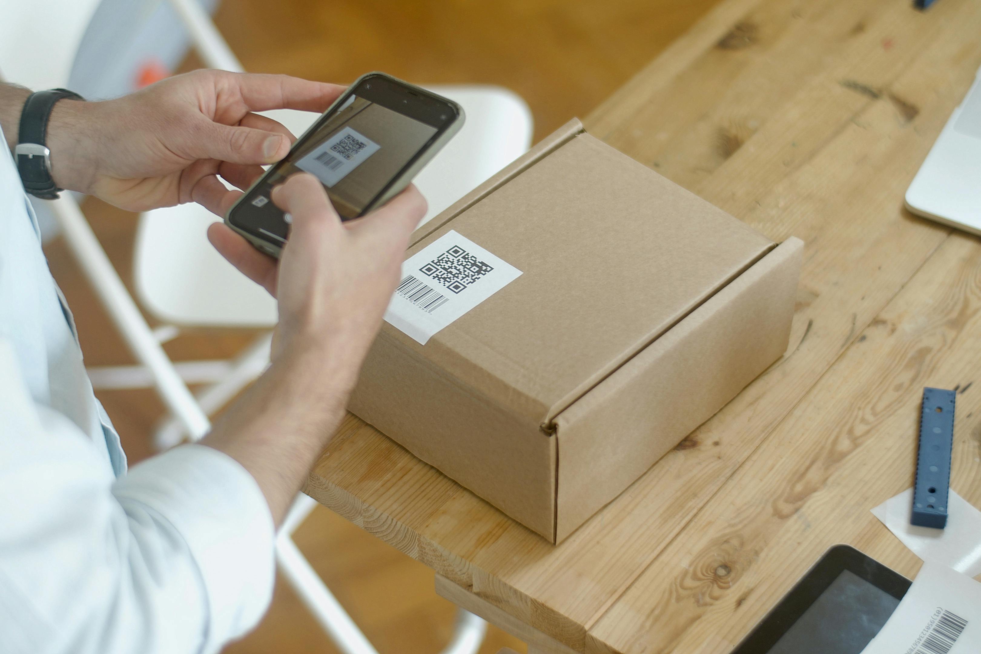 person taking a picture of package qr code