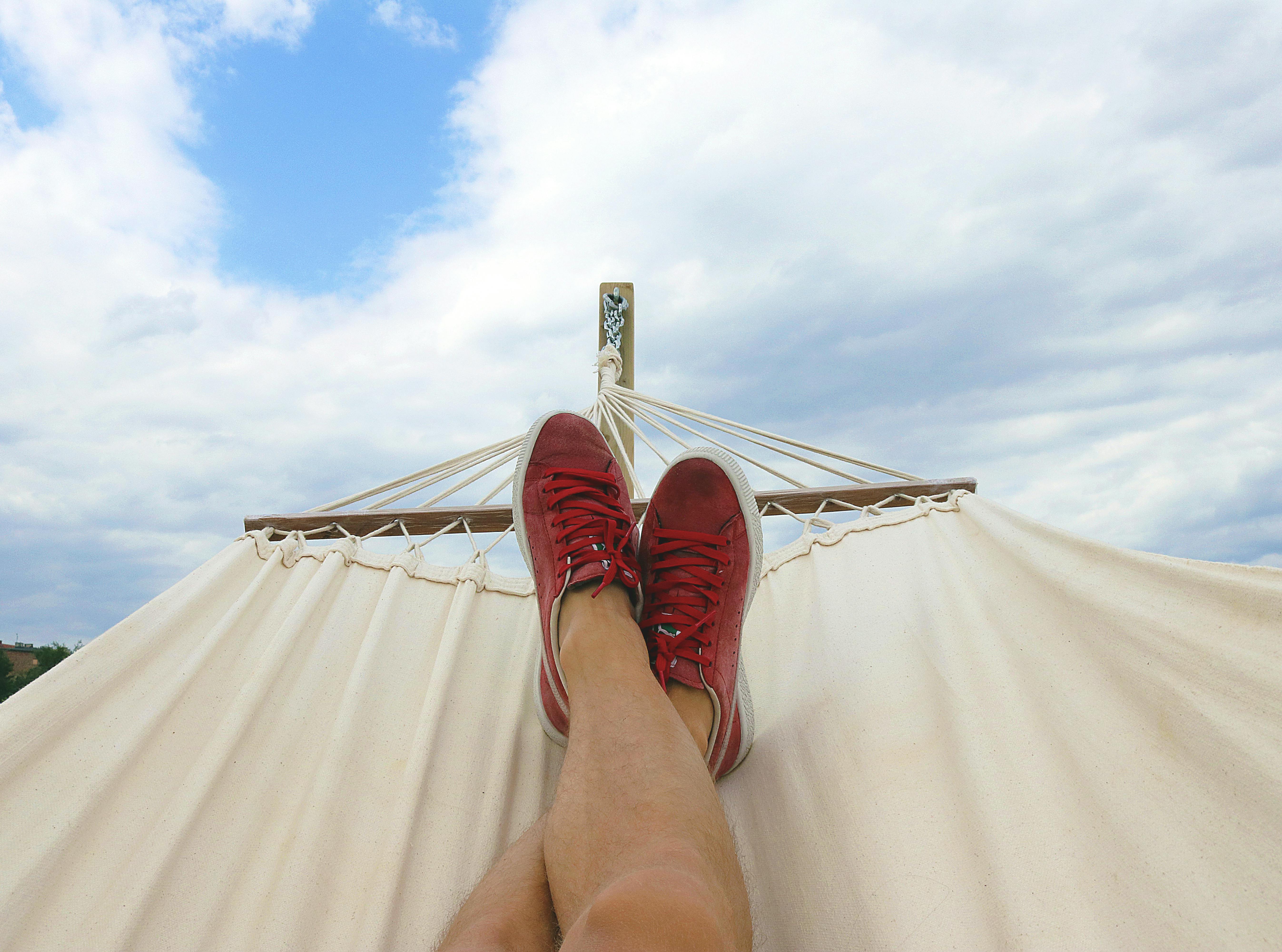 Relaxing in a hammock, cloudy sky.