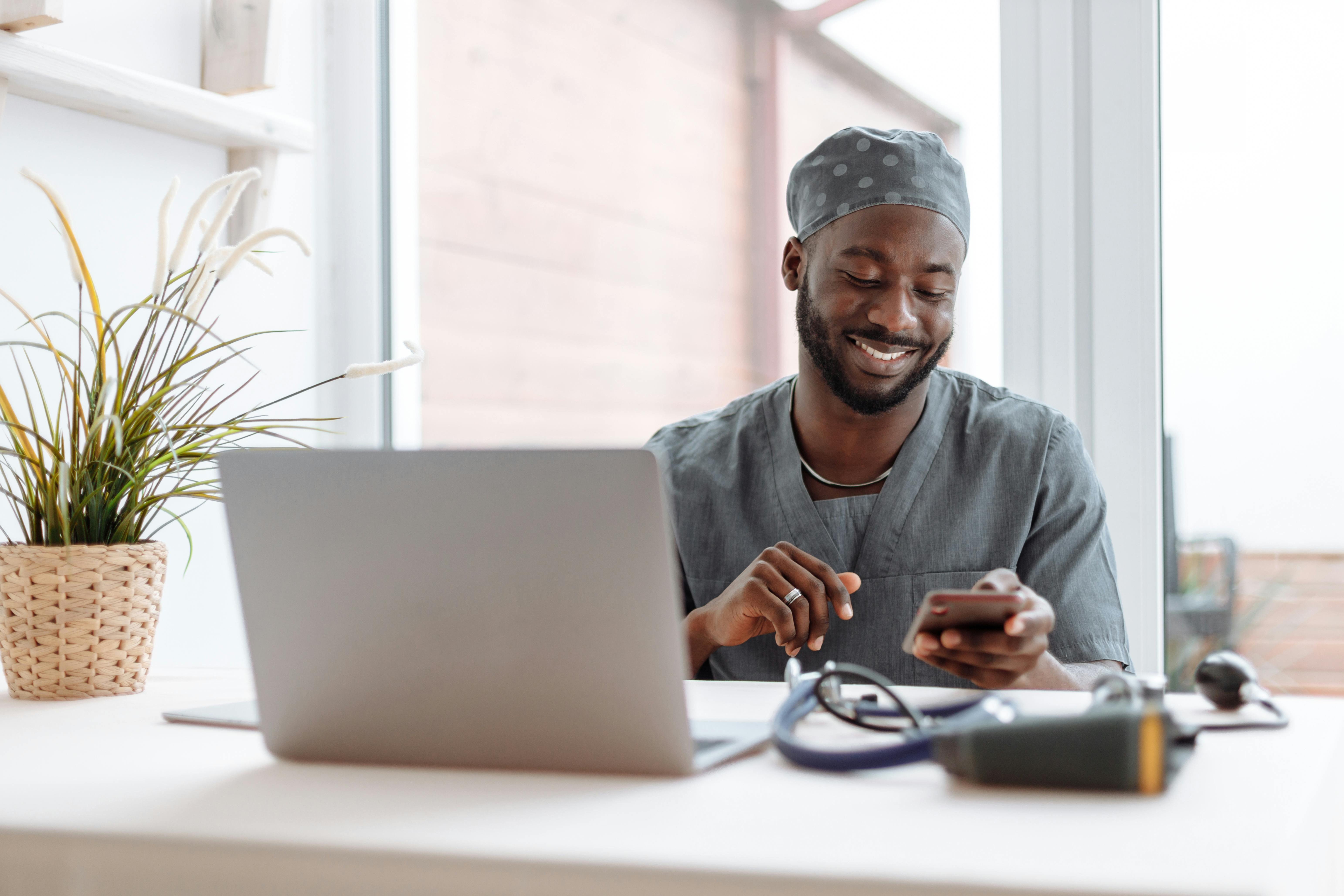 Person working at a desk with technology.