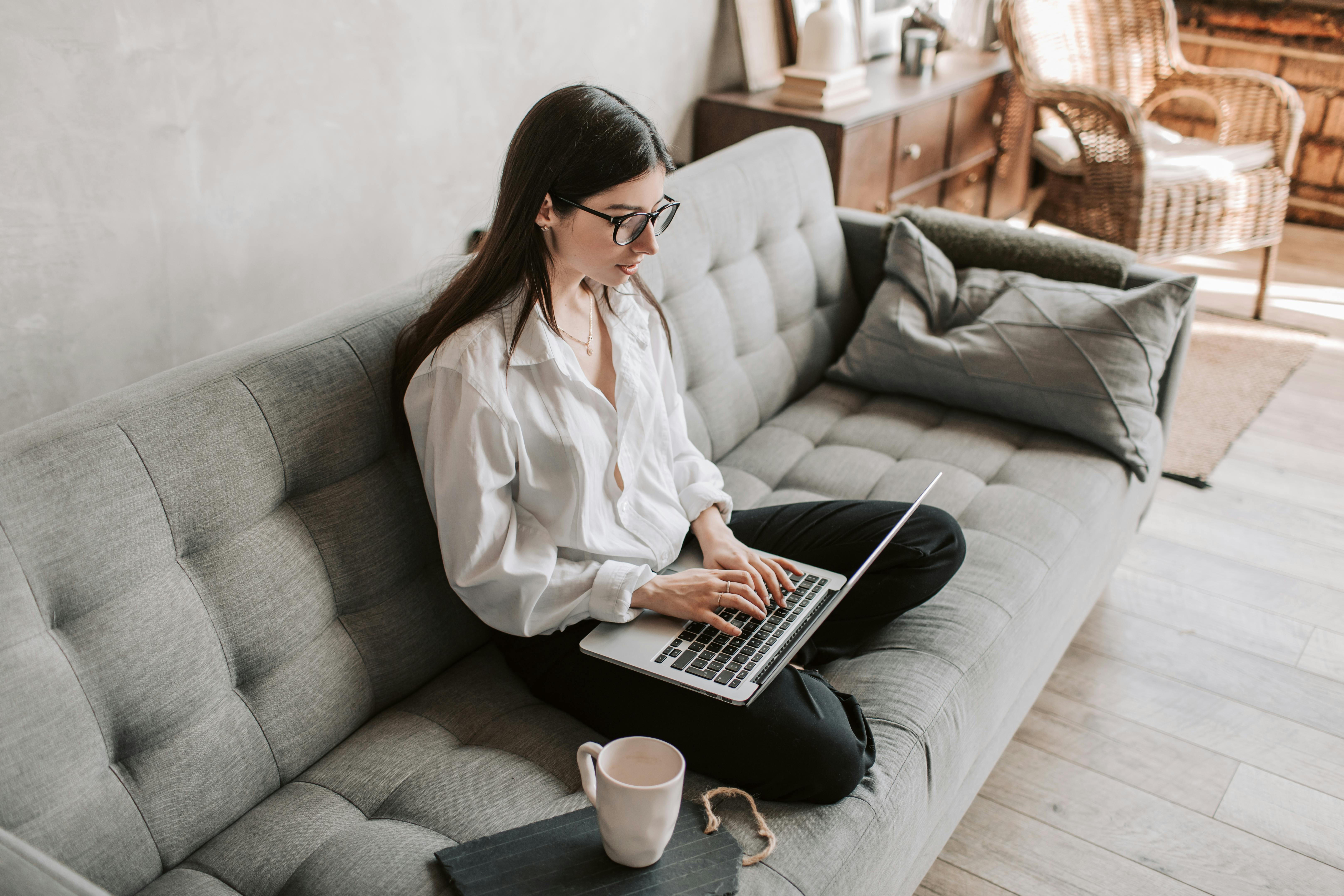 woman sitting cross legged on couch
