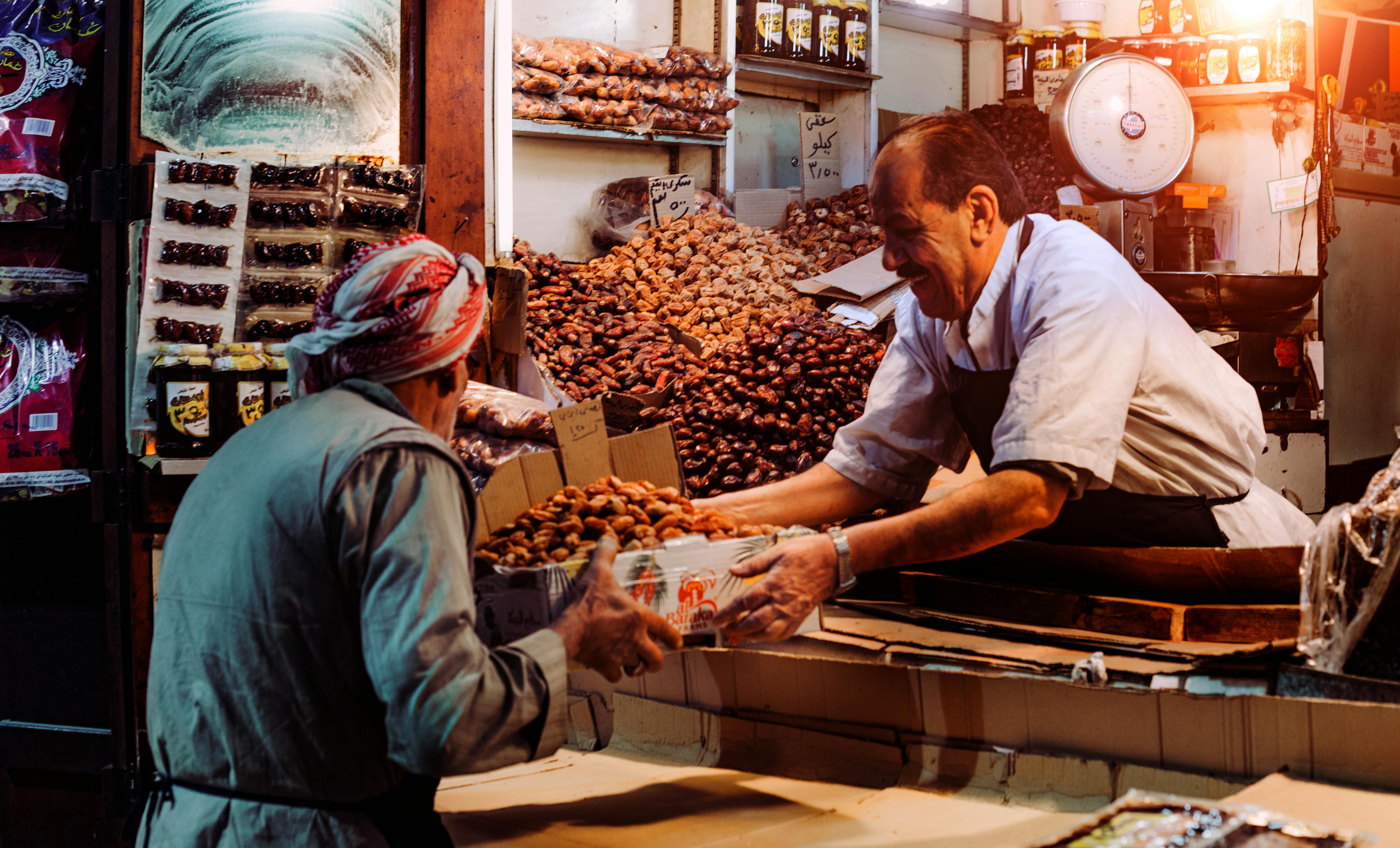 Market scene with dates being exchanged.
