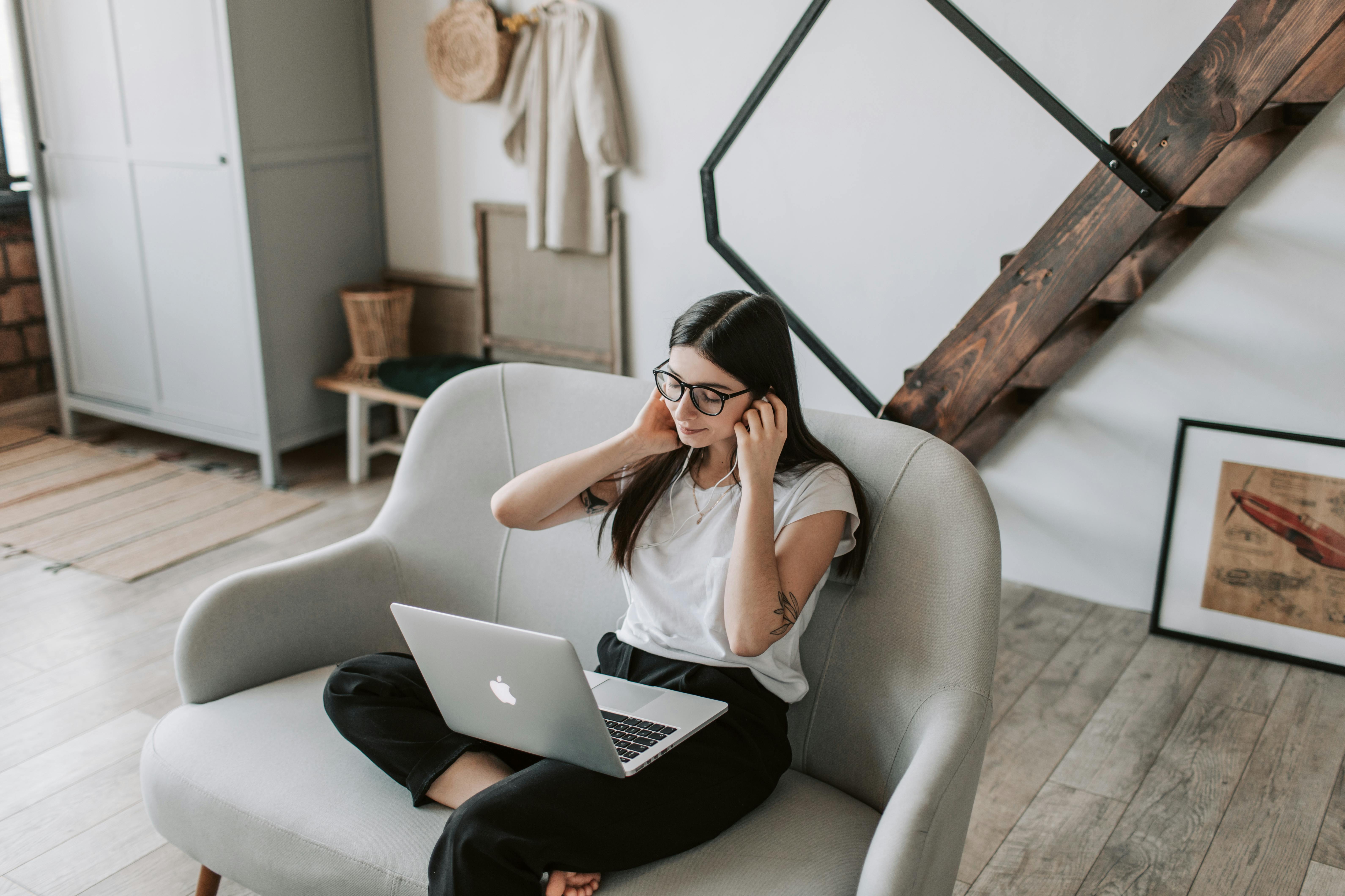 woman sitting on the couch on her laptop