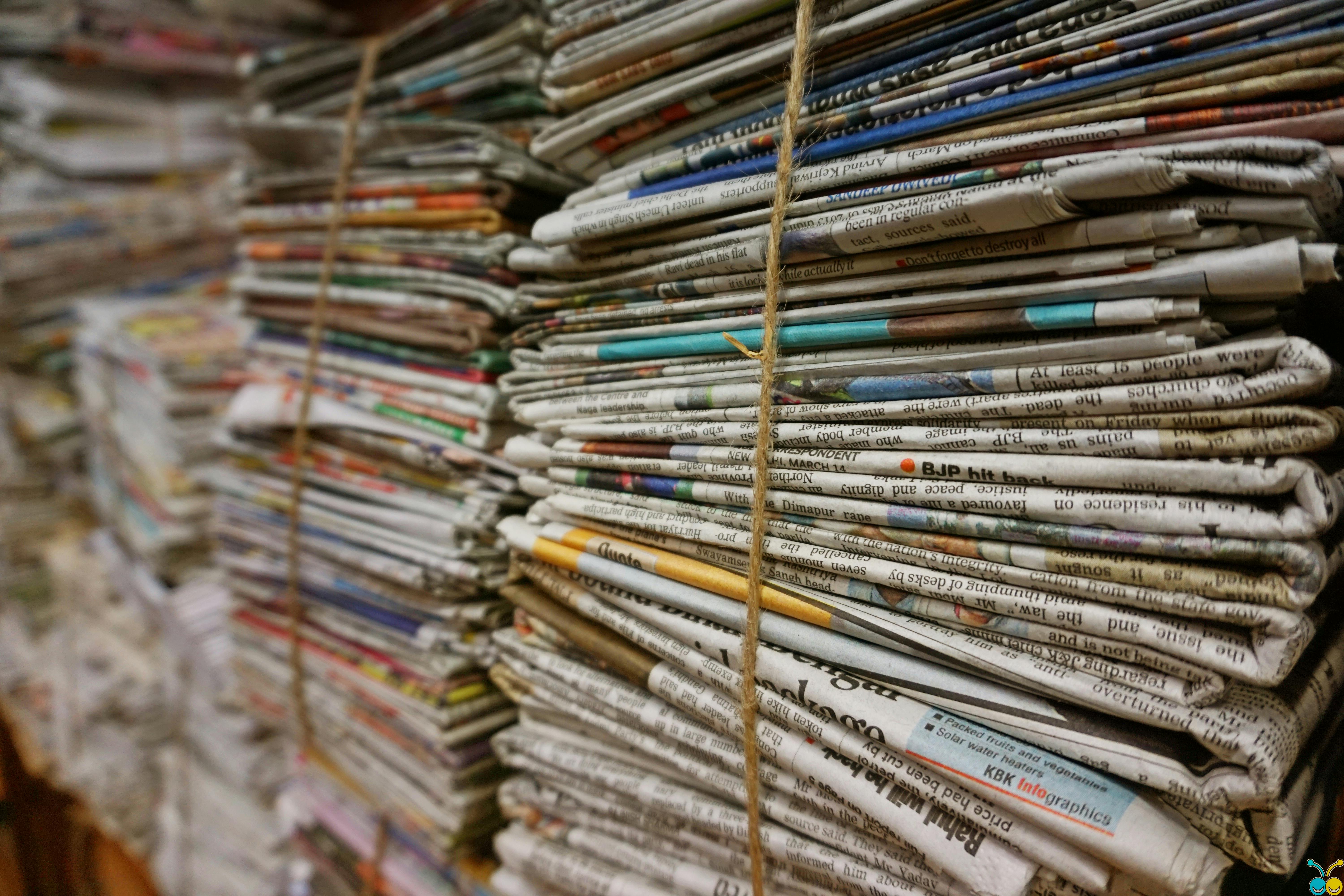 Stacked newspapers tied with string