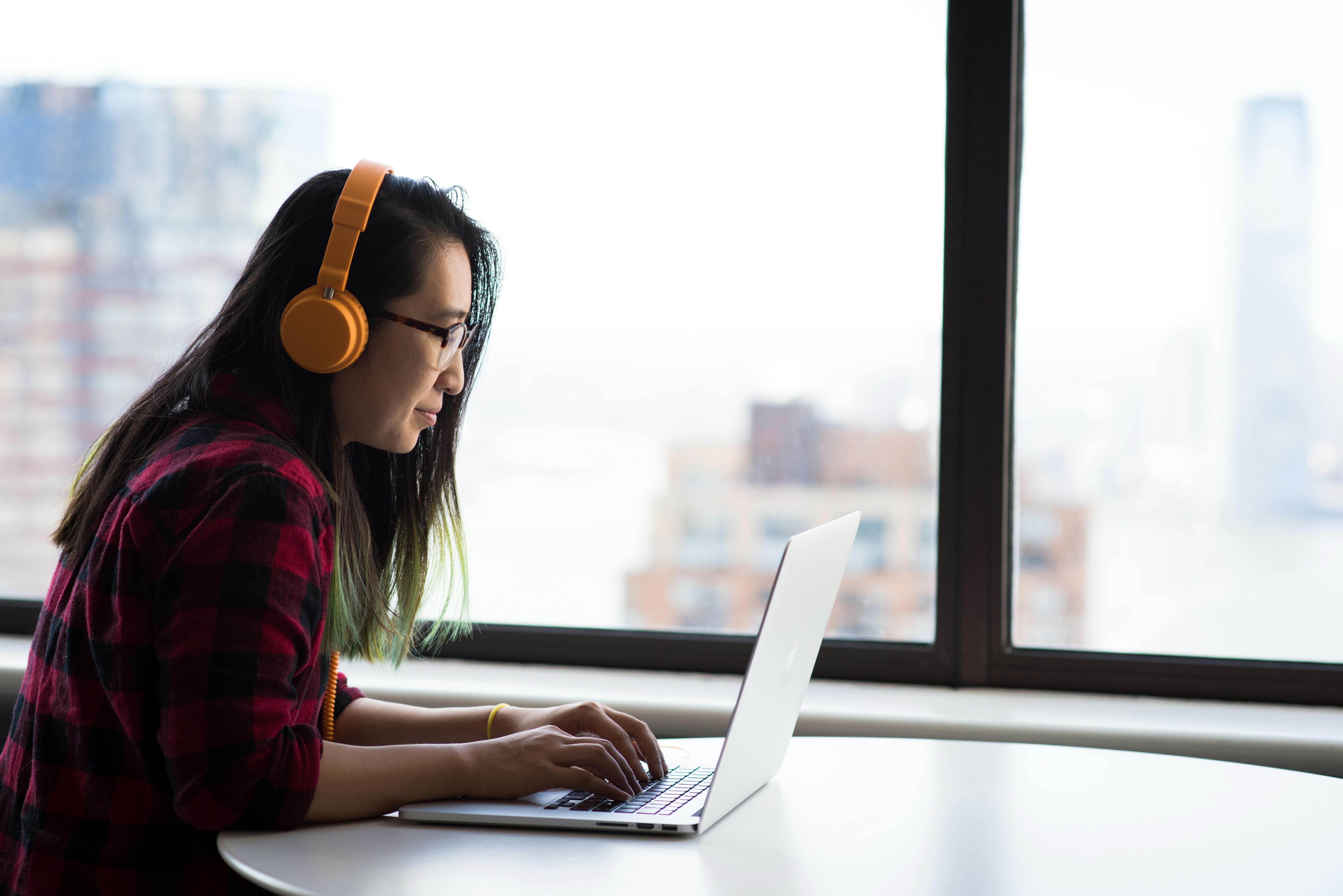 woman on laptop with headphones on