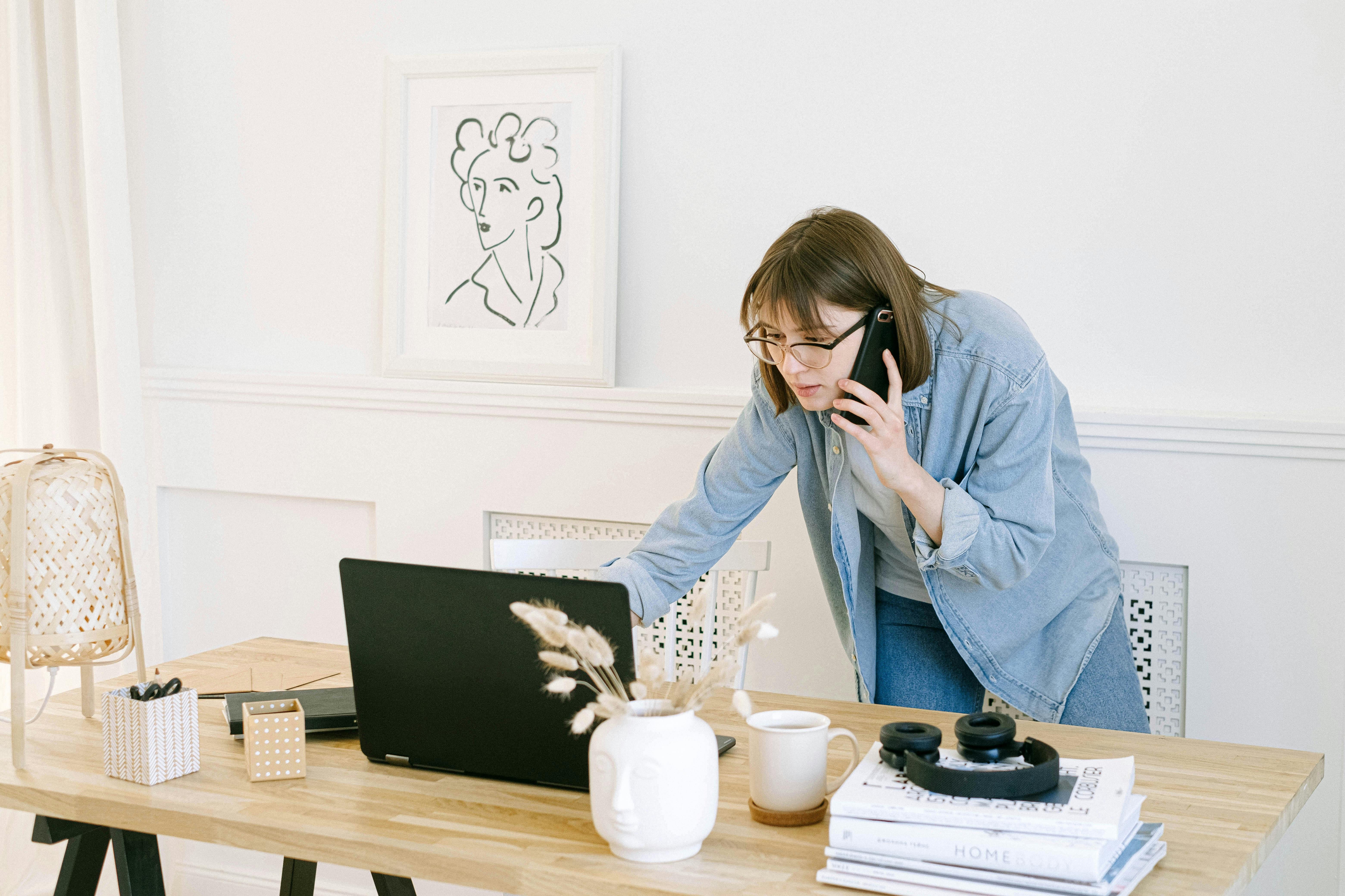 woman on both phone and laptop