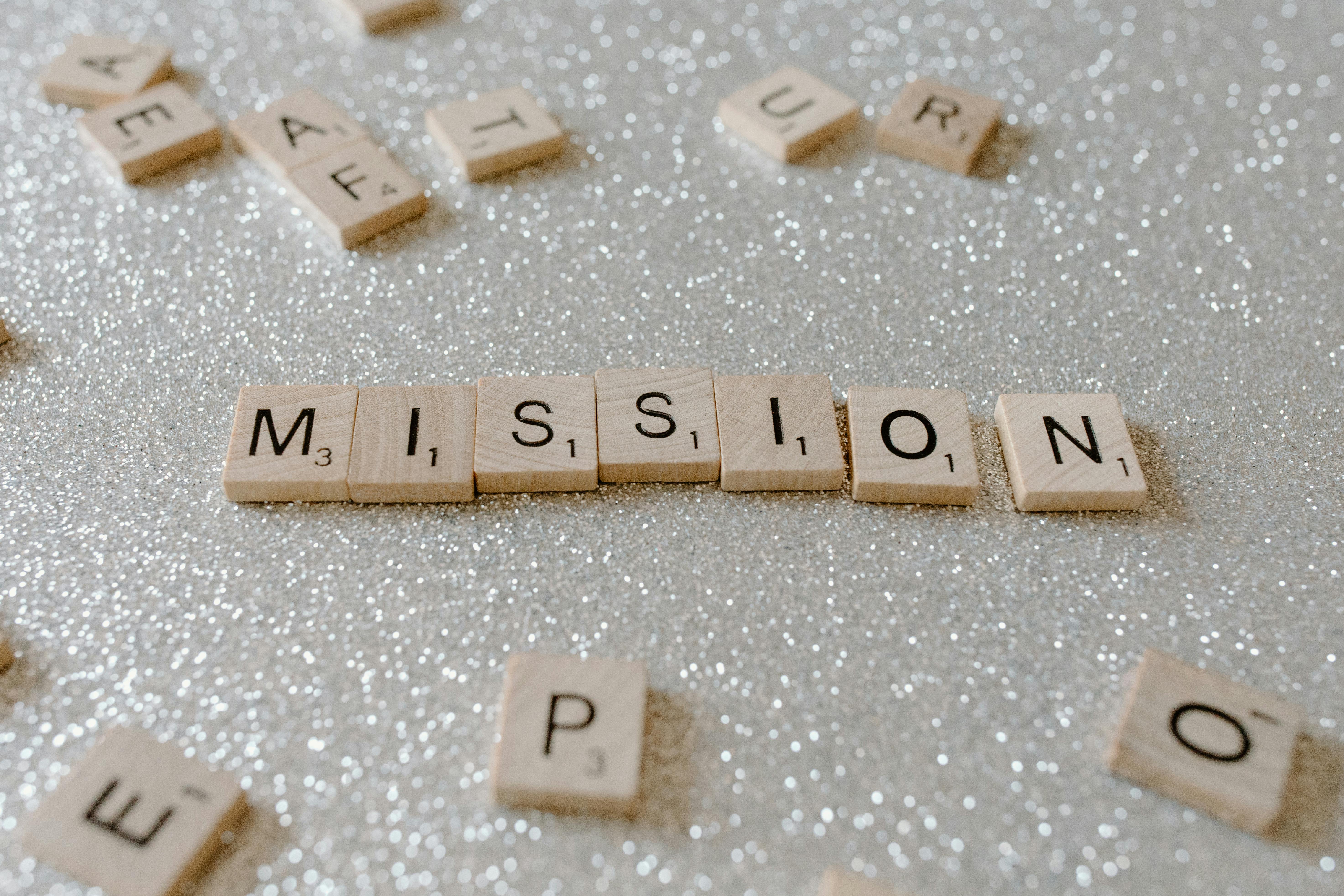 scrabble tiles spelling "mission"