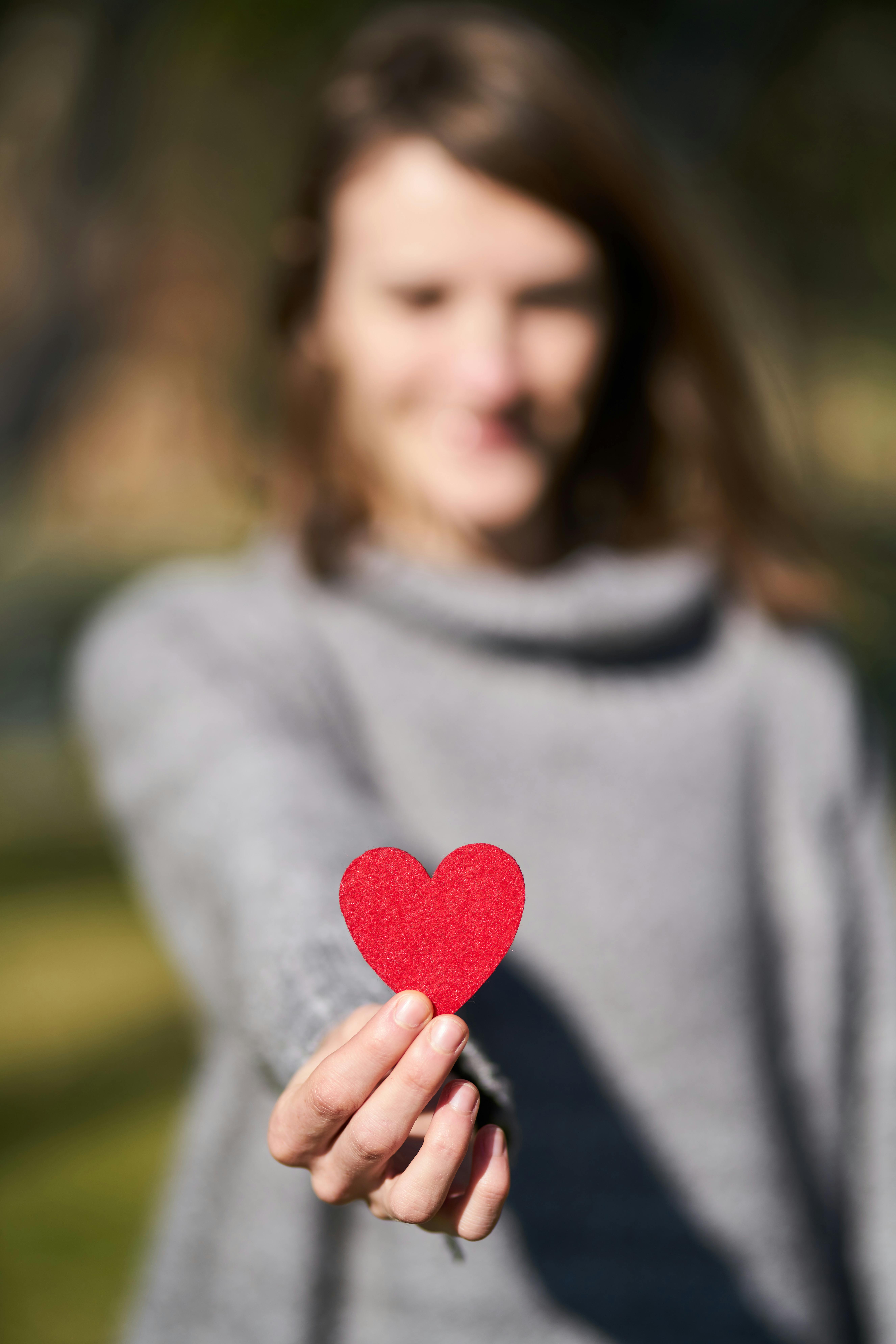 Woman showing a paper mache heart