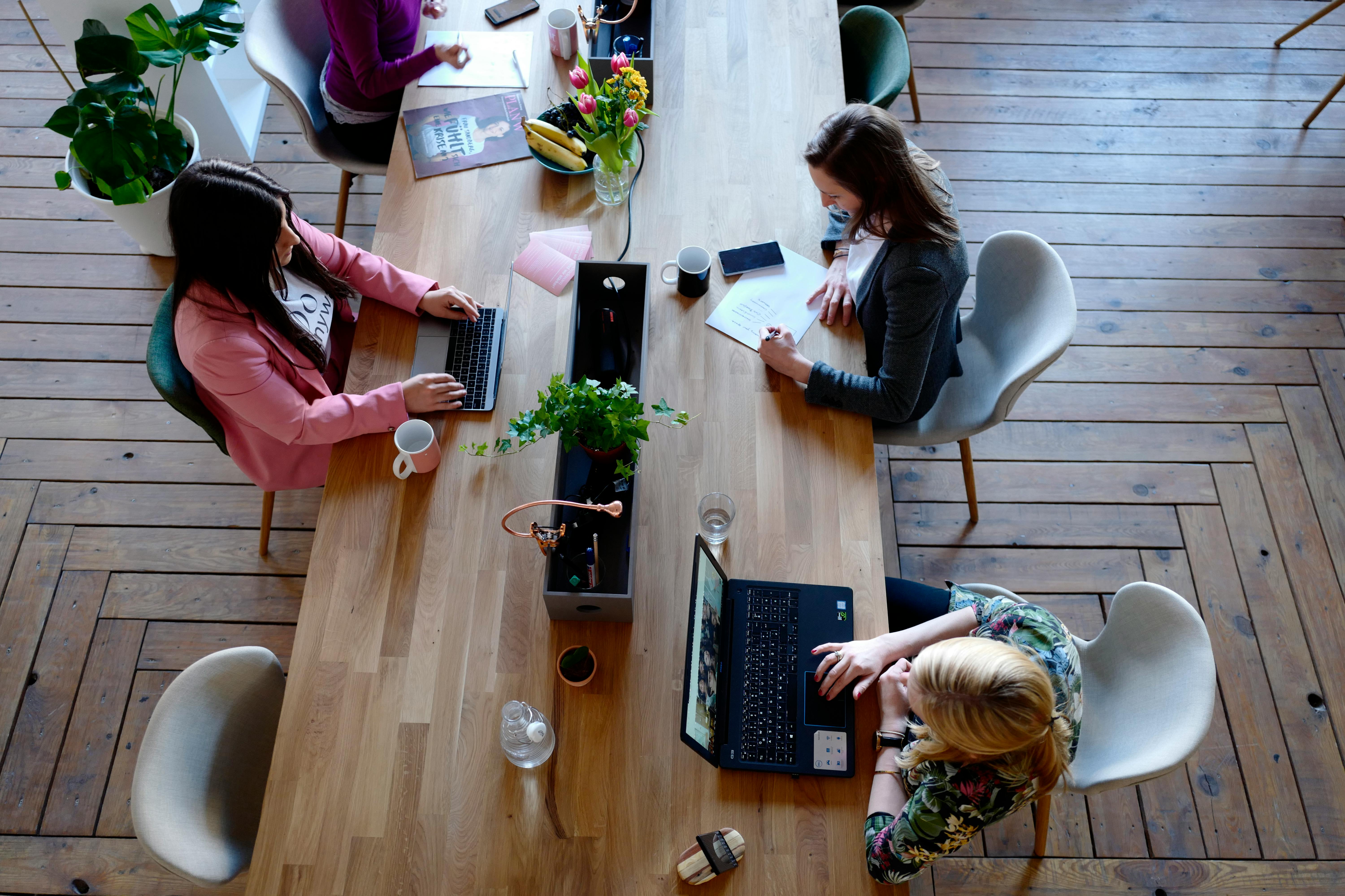 Women working collaboratively at a table.